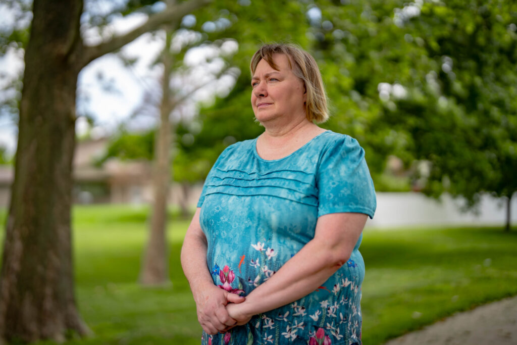 Jacque Palczynski, the mother of a son who struggles with a serious mental illness, poses for a photo June 6. Palczynski has tried several times to commit her son and force him to receive treatment for his schizoaffective disorder. But the safety net in Douglas County has not helped, she said, which has led her son to cycling in and out of hospitals and jail. Photo by Abiola Kosoko for Flatwater Free Press